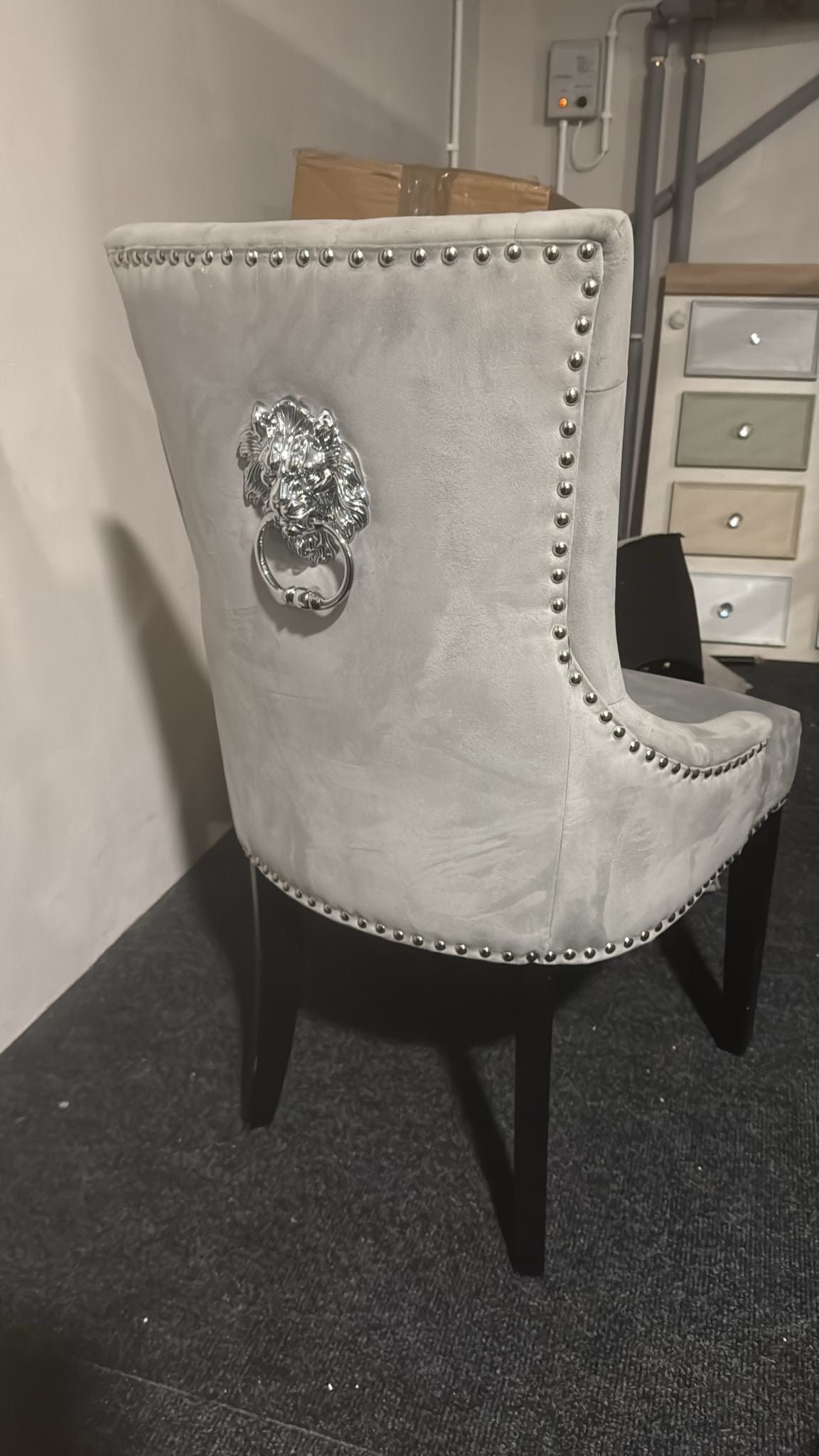 Shop display Grey velvet knocker chair with lion head black wood leg